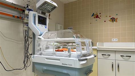 Inkubátor s predčasne narodeným dieťaťom a monitormi životných funkcií