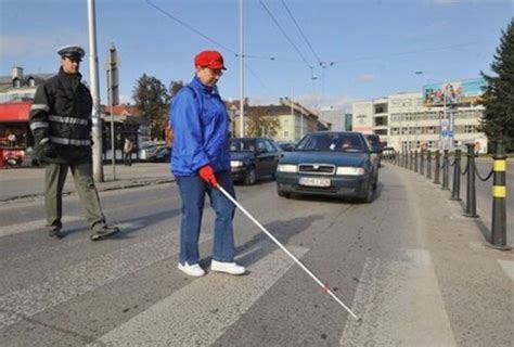 Zrakovo postihnutý človek s bielou palicou v meste